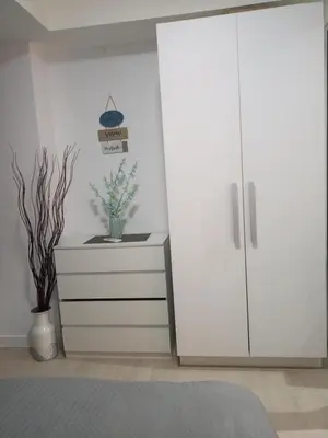 a bedroom with a dresser and a white cabinet at Azure Urban Resort Residences in Manila