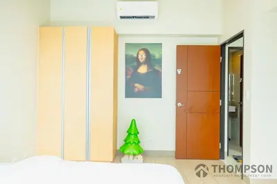 a bedroom with a bed and a christmas tree in it at Family 2 Bedroom and 1 living Room Suite with Balcony - One Uptown, BGC in Manila