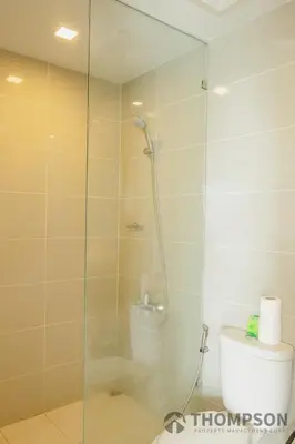 a bathroom with a glass shower with a toilet at Family 2 Bedroom and 1 living Room Suite with Balcony - One Uptown, BGC in Manila