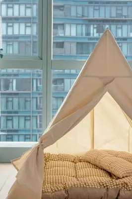 a bed with a tent on it in front of a window at Family 2 Bedroom and 1 living Room Suite with Balcony - One Uptown, BGC in Manila