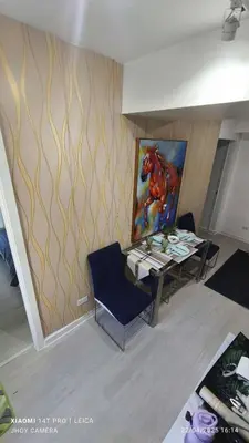 a room with a table and a painting on the wall at AZURE BICUTAN BORACAY 4FL BEACH POOL View in Manila