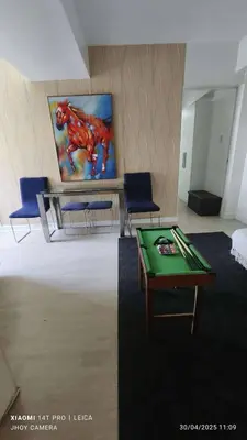 a room with a table and two chairs and a painting at AZURE BICUTAN BORACAY 4FL BEACH POOL View in Manila