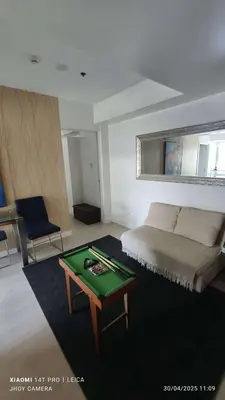a bedroom with a bed and a green table at AZURE BICUTAN BORACAY 4FL BEACH POOL View in Manila