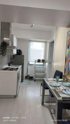 a kitchen with a table and a dining room at AZURE BICUTAN BORACAY 4FL BEACH POOL View in Manila