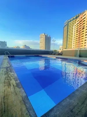 a swimming pool on the roof of a building at I Suites Hotel Malate in Malate