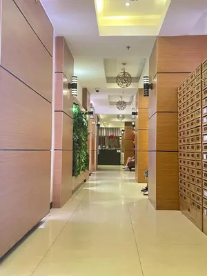 a hallway in a building with wooden walls and a lobby at I Suites Hotel Malate in Malate