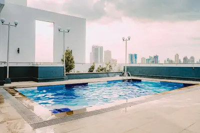 a swimming pool on the roof of a building at I Suites Hotel Malate in Malate