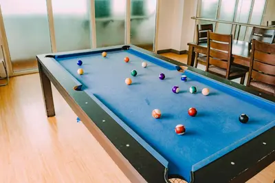a pool table with balls on top of it at I Suites Hotel Malate in Malate