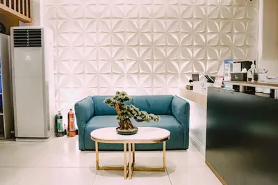 a blue couch and a table in a store at I Suites Hotel Malate in Malate