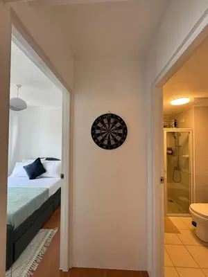 a bedroom with a bed and a clock on the wall at Modern Minimalist Luxe Retreat 2 Bedroom with parking in Manila