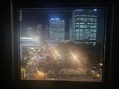 a view from a window of a city at night at Entire Studio Unit Classio De Condotel at Urban Deca Cubao in Manila