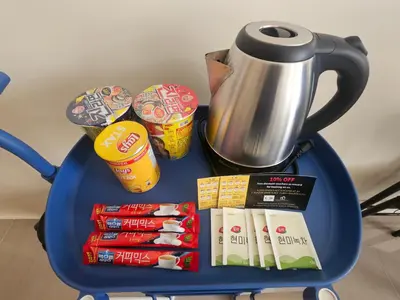 a blue table with a tea pot and some snacks at Entire Studio Unit Classio De Condotel at Urban Deca Cubao in Manila