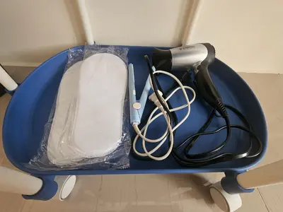 a blue tray with a hair dryer and a blow dryer at Entire Studio Unit Classio De Condotel at Urban Deca Cubao in Manila