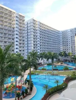 a view of a resort with a large swimming pool at Sebby's staycation at Shell MOA in Manila