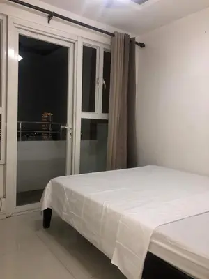 a bedroom with a white bed and a window at Birch Tower A8 Front of Robinson Mla BayFree Pool in Manila