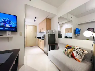 a living room with a couch and a flat screen tv at 1BR Condotel with Balcony at SM Light Residences #LT01-1 in Manila