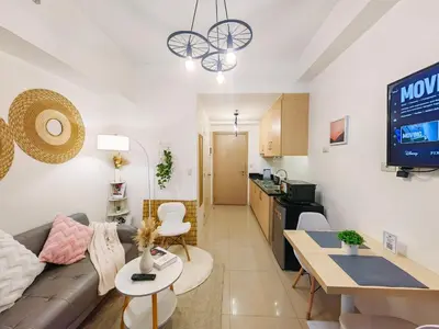 a living room with a couch and a table at 1BR Condotel with Balcony at SM Light Residences #LT02-1 in Manila