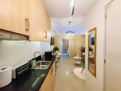 a kitchen with a sink and a counter top at 1BR Condotel with Balcony at SM Light Residences #LT02-1 in Manila