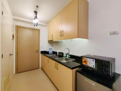 a small kitchen with a sink and a microwave at 1BR Condotel with Balcony at SM Light Residences #LT02-1 in Manila
