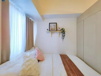 a small bedroom with a bed and a window at 1BR Condotel with Balcony at SM Light Residences #LT02-1 in Manila