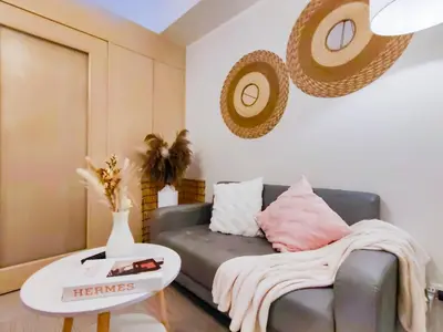 a living room with a couch and a table at 1BR Condotel with Balcony at SM Light Residences #LT02-1 in Manila