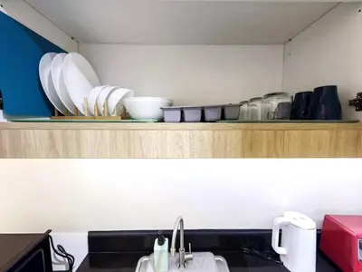 a kitchen with a sink and a shelf with dishes at 1BR Condotel with Balcony at SM Light Residences #LT03-1 in Manila