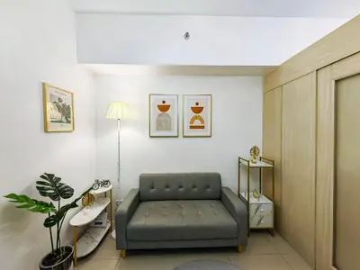 a living room with a couch in a room at 1BR Condotel with Balcony at SM Light Residences #LT03-1 in Manila