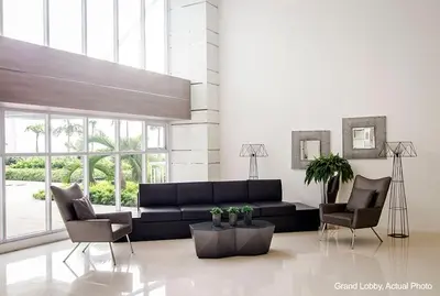a living room with a black couch and two chairs at 1BR Condotel with Balcony at SM Light Residences #LT04-1 in Manila