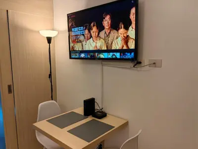 a flat screen tv hanging on a wall at 1BR Condotel with Balcony at SM Light Residences #LT04-1 in Manila