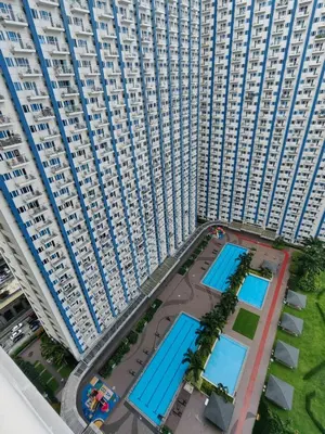 an overhead view of a large building with swimming pools at 1BR Condotel with Balcony at SM Light Residences #LT04-1 in Manila