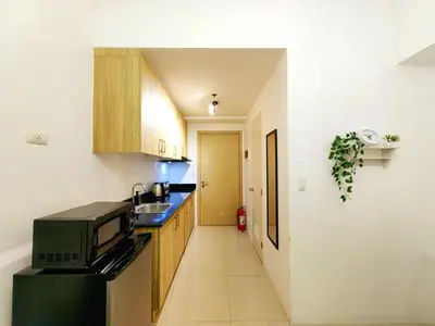 a small kitchen with a sink and a microwave at 1BR Condotel with Balcony at SM Light Residences #LT05-1 in Manila