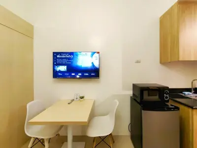 a small room with a table and a television on the wall at 1BR Condotel with Balcony at SM Light Residences #LT05-1 in Manila