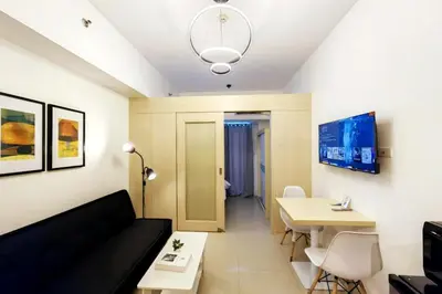 a living room with a couch and a table at 1BR Condotel with Balcony at SM Light Residences #LT05-1 in Manila