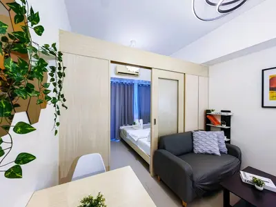 a small room with a chair and a bed at 1BR Condotel with Balcony at SM Light Residences #LT06-1 in Manila