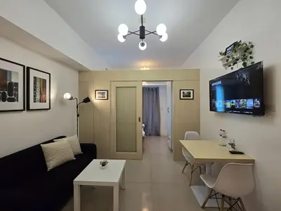 a living room with a couch and a table at 1BR Condotel with Balcony at SM Light Residences #LT07-1 in Manila
