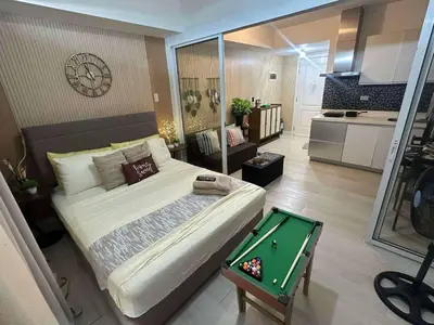 a bedroom with a bed and a pool table at AZURE BICUTAN-MAUI 1631 City View in Manila