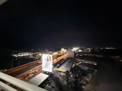 a building with a picture of a woman on it at night at AZURE BICUTAN-MAUI 1631 City View in Manila
