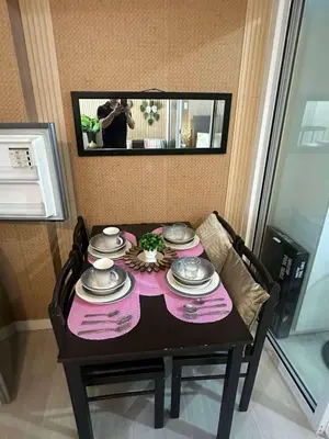 a table with plates and dishes on top of it at AZURE BICUTAN-MAUI 1631 City View in Manila