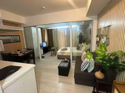 a living room with a couch and a bedroom at AZURE BICUTAN-MAUI 1631 City View in Manila