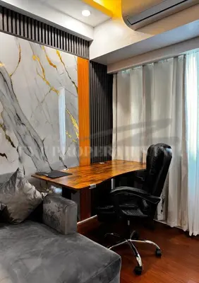 an office with a wooden desk and a chair at Lux Staycation at Shore 3, MOA in Manila