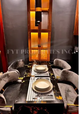 a dining room table with chairs and plates on it at Lux Staycation at Shore 3, MOA in Manila