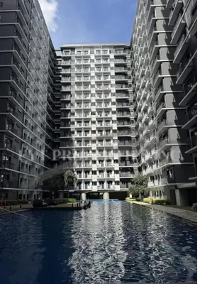 two large apartment buildings next to a pool of water at Lux Staycation at Shore 3, MOA in Manila