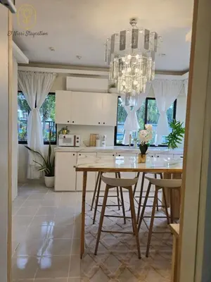 a kitchen with a dining table and a chandelier at El Nissi Staycation, The Farmhouse Suite, Enchanted Kingdom in Santa Rosa