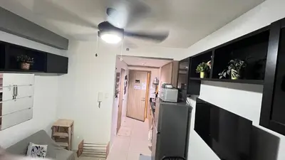 a room with a kitchen with a ceiling fan at STARR VACATION Condo in Manila