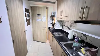 a small kitchen with a sink and a counter at STARR VACATION Condo in Manila