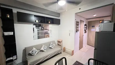 a living room with a couch in a room at STARR VACATION Condo in Manila