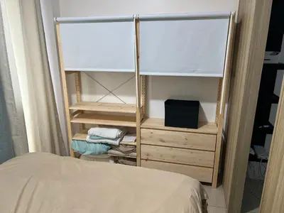 a bedroom with a bed and a dresser at STARR VACATION Condo in Manila