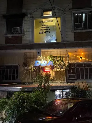 a sign on the side of a building at night at D and A Transient Inn Taguig in Taguig
