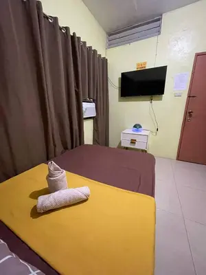 a hotel room with a bed with a towel on it at D and A Transient Inn Taguig in Taguig