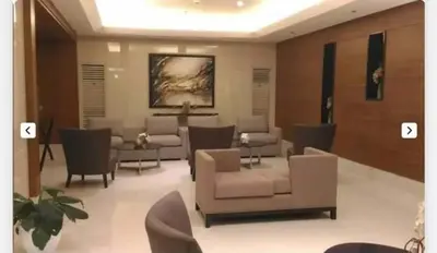 a living room with couches and tables and chairs at La Maison Breeze Residence in Manila
